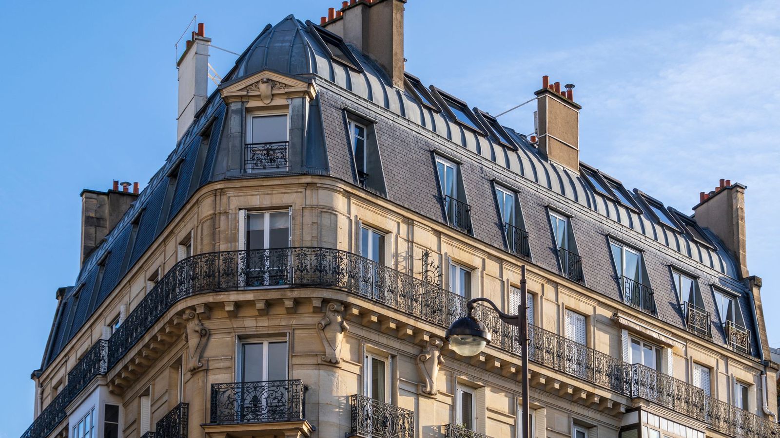 Haussmann apartment building in Paris with wrought-iron balconies and a zinc mansard roof